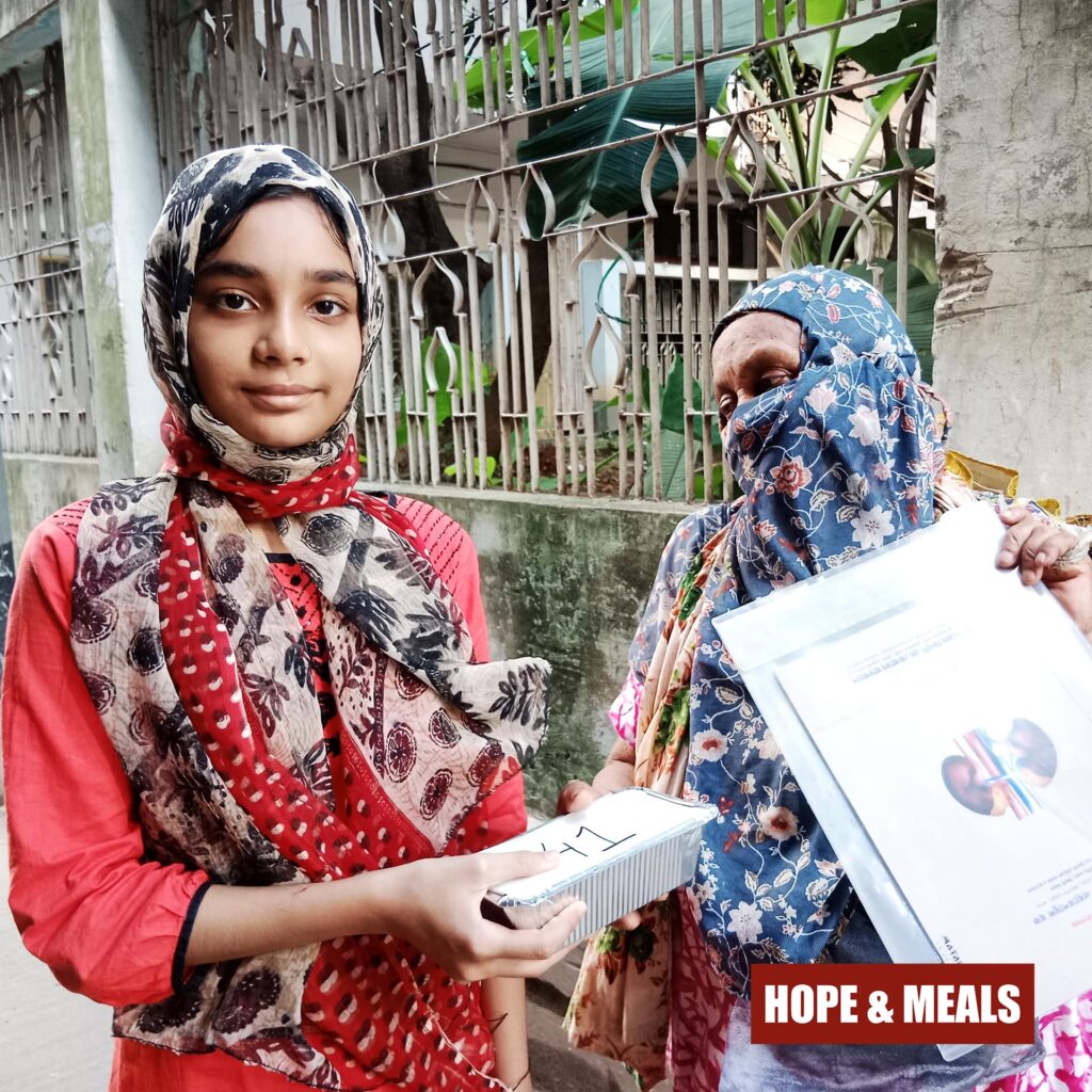 Hope & Meals volunteers serving fresh meal boxes with love and dedication.